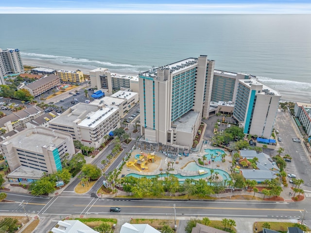 drone / aerial view with a beach view and a water view