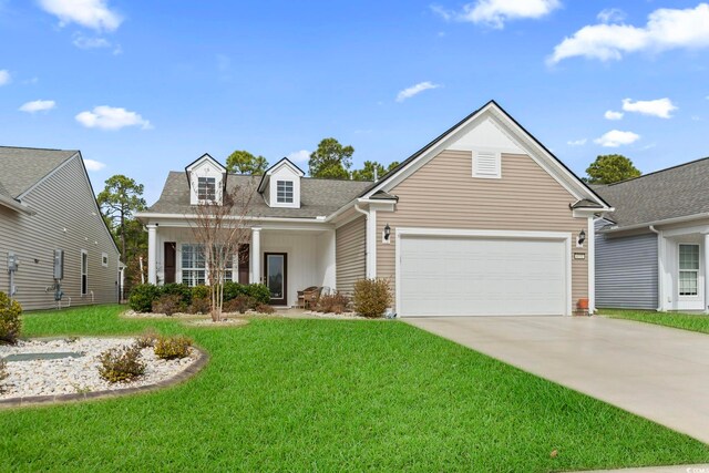 view of front of home with a front yard and a garage