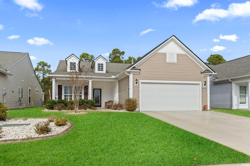 view of front of home with a front yard and a garage