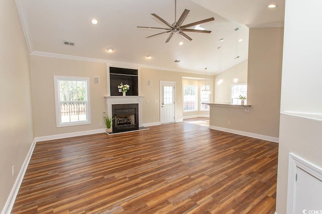 unfurnished living room with a fireplace, ceiling fan, ornamental molding, and dark hardwood / wood-style floors