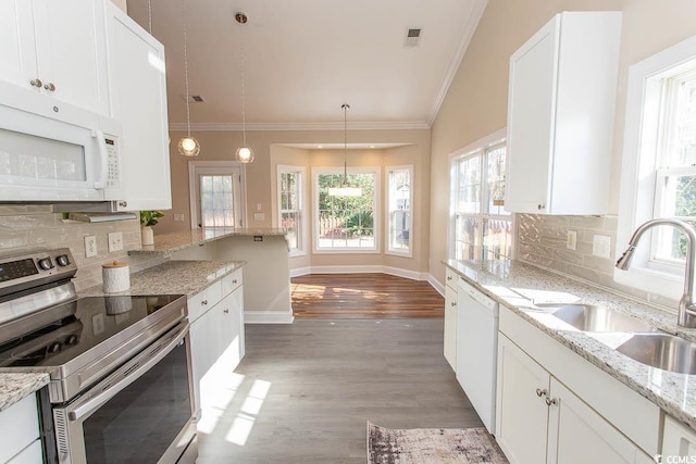 kitchen featuring sink, decorative light fixtures, white cabinets, white appliances, and tasteful backsplash