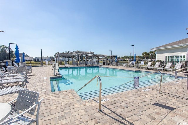 view of swimming pool with a pergola and a patio