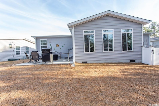 rear view of property with a patio and a lawn