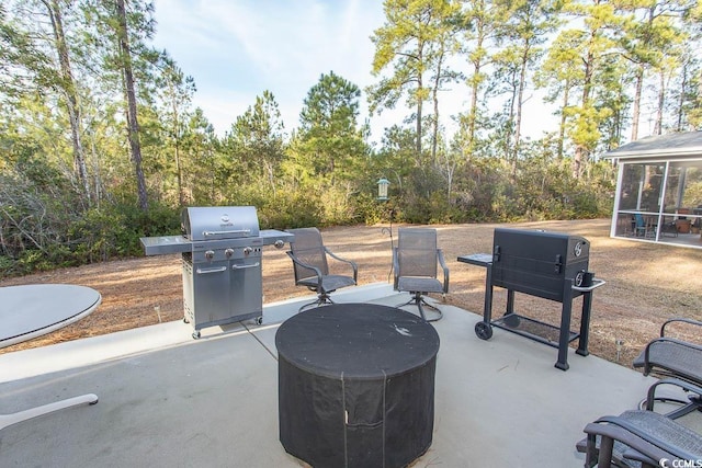 view of patio / terrace with grilling area and a sunroom