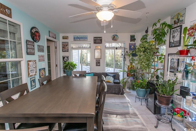 dining space featuring ceiling fan and light tile patterned floors