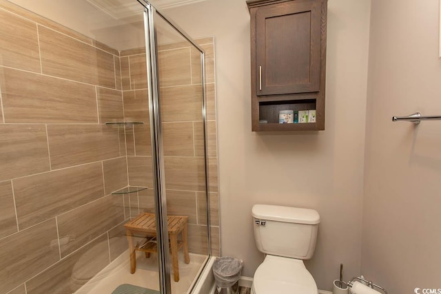 bathroom featuring toilet and walk in shower