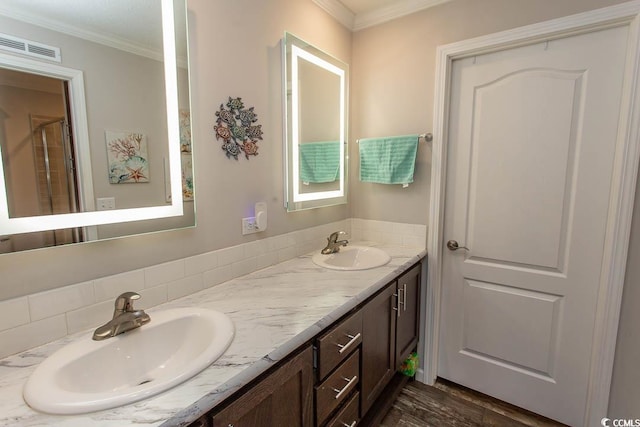 bathroom with hardwood / wood-style floors, vanity, and ornamental molding