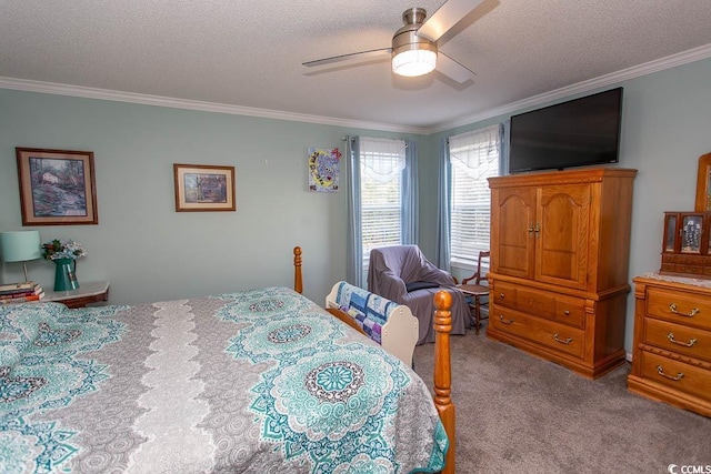 carpeted bedroom with a textured ceiling, ceiling fan, and crown molding