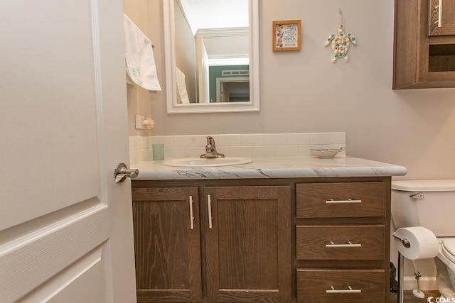 bathroom with toilet and vanity