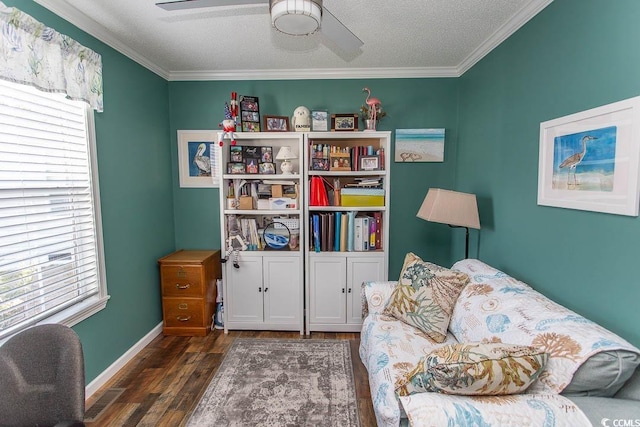 sitting room with dark hardwood / wood-style flooring, a textured ceiling, crown molding, and a wealth of natural light