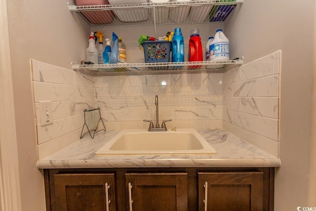 interior space with sink and decorative backsplash