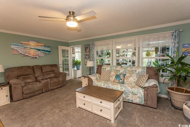 living room with a textured ceiling, ceiling fan, carpet, and crown molding