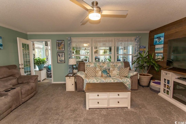 living room with a textured ceiling, ornamental molding, wooden walls, and carpet flooring