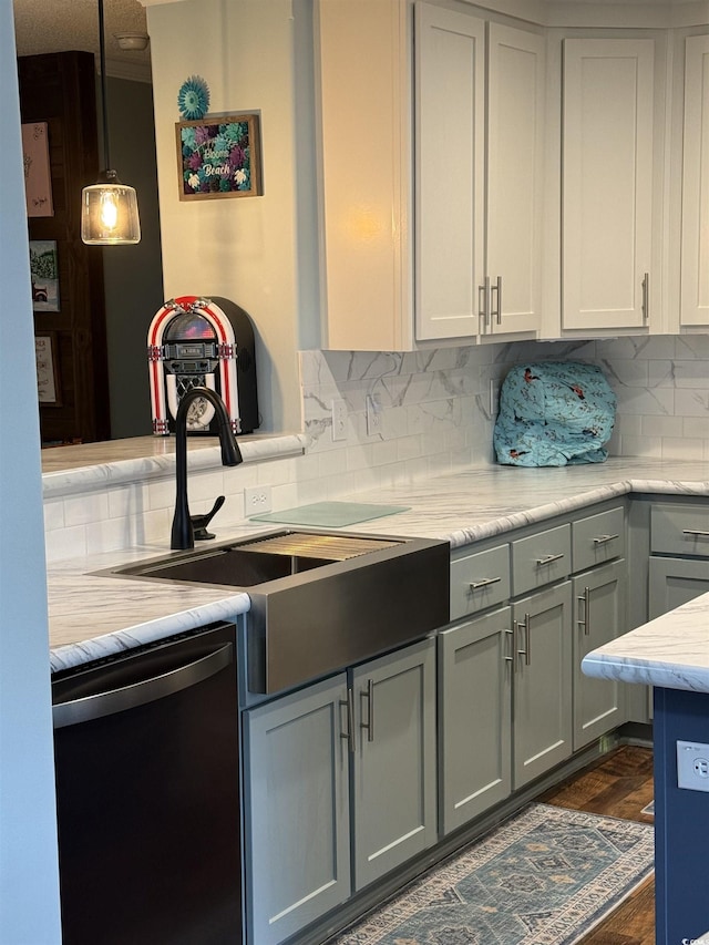 kitchen featuring dishwasher, decorative backsplash, dark hardwood / wood-style flooring, gray cabinetry, and sink