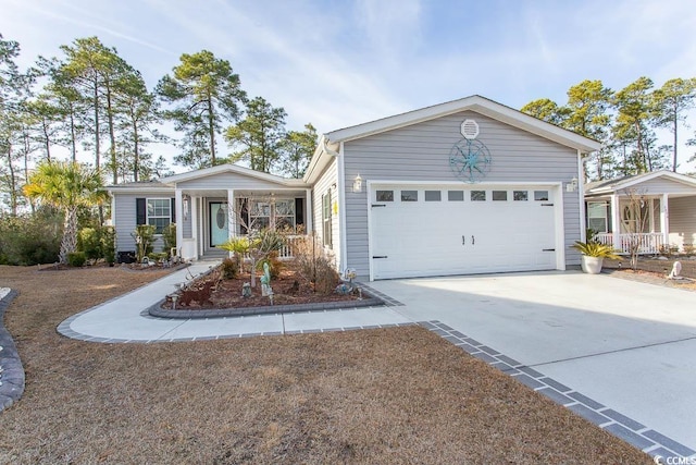 ranch-style house featuring covered porch and a garage