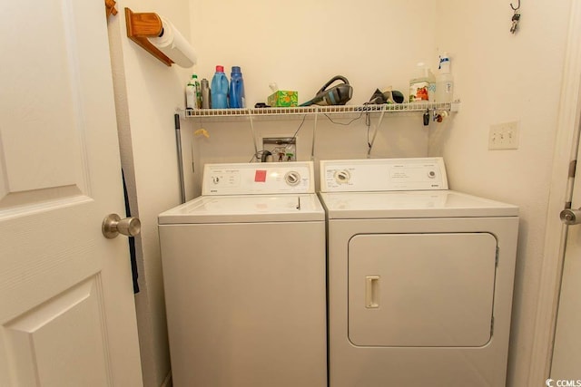 laundry room featuring washing machine and clothes dryer