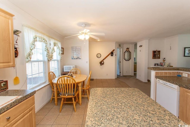 dining room featuring ceiling fan, light tile patterned floors, and crown molding