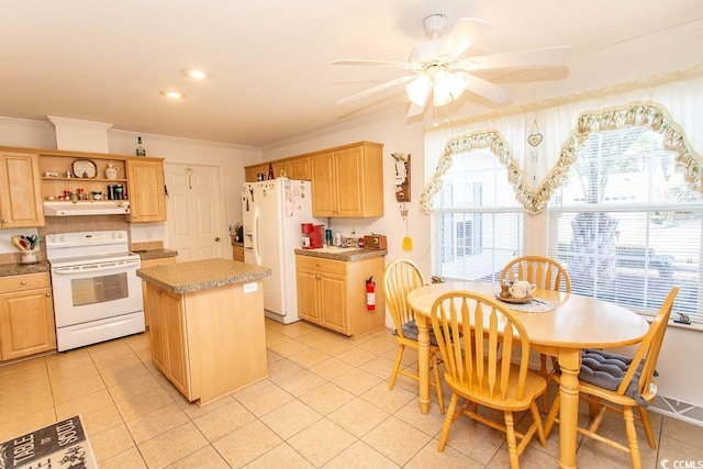 kitchen with a center island, white appliances, light tile patterned flooring, ornamental molding, and ceiling fan