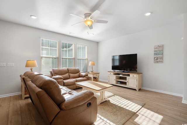 living room with ceiling fan and light hardwood / wood-style floors