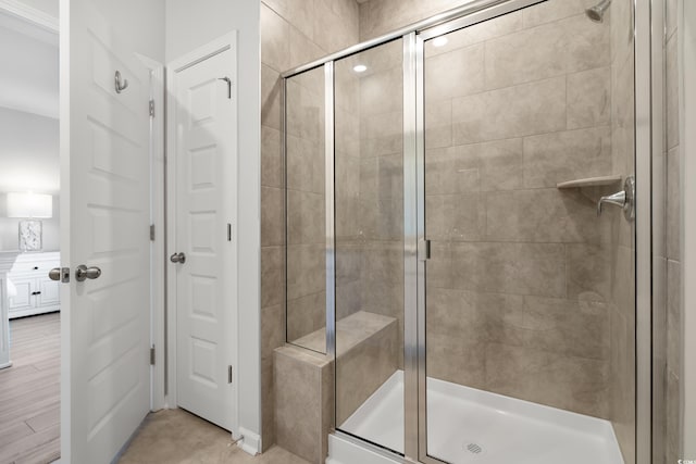 bathroom featuring a shower with shower door