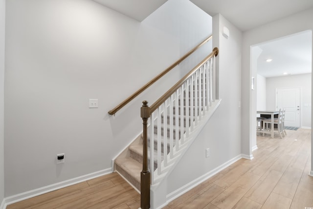 stairs with wood-type flooring