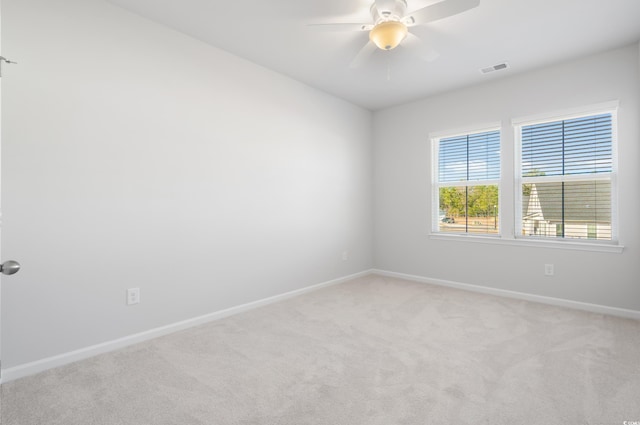 carpeted spare room featuring ceiling fan