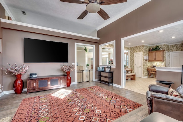 living room featuring ceiling fan and ornamental molding