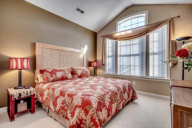 carpeted bedroom featuring multiple windows and vaulted ceiling