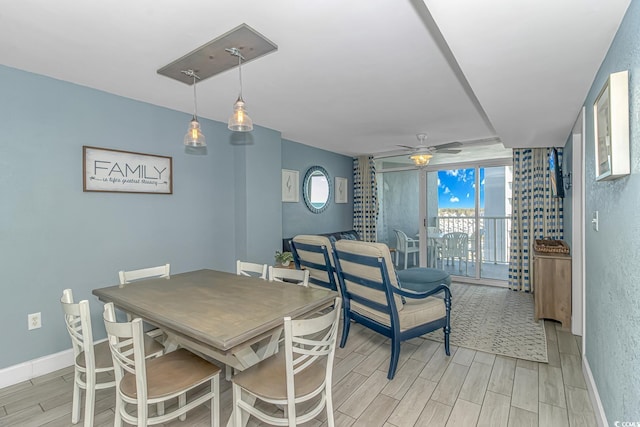 dining room with baseboards, a ceiling fan, and wood tiled floor