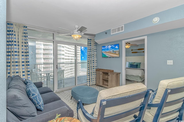 living room featuring visible vents and a ceiling fan