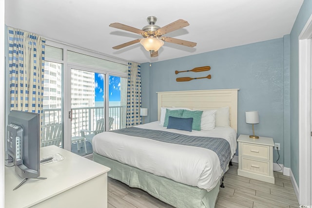 bedroom featuring baseboards, a ceiling fan, access to exterior, and wood tiled floor