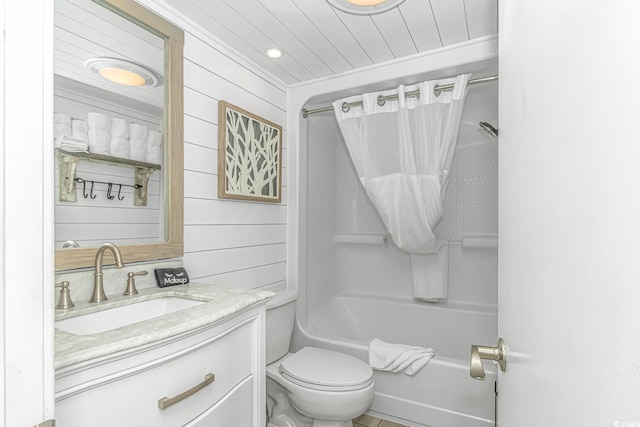 bathroom with vanity, shower / tub combo, toilet, and wood walls