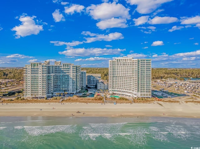 birds eye view of property with a view of the beach and a water view