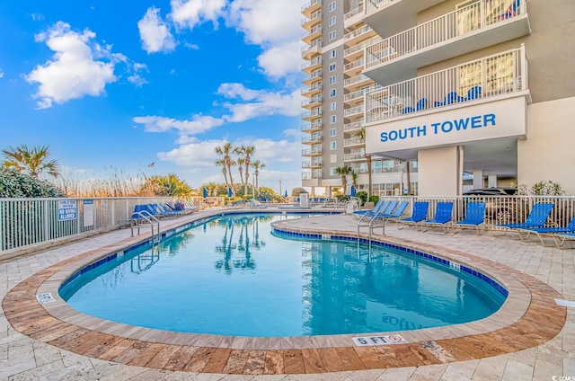 pool featuring a patio area and fence