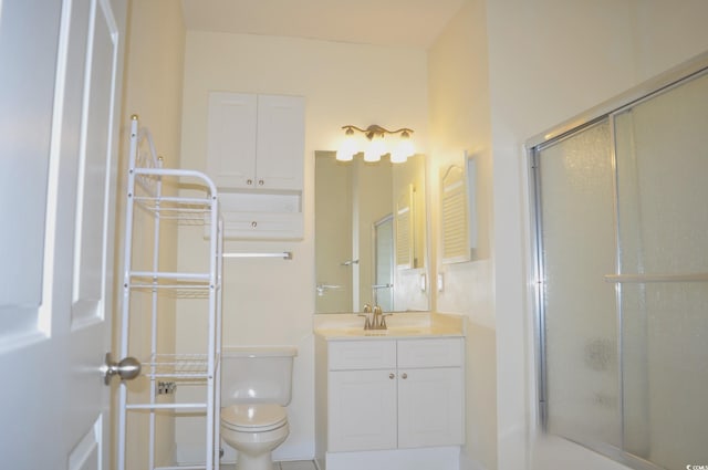 bathroom featuring vanity, toilet, and an enclosed shower