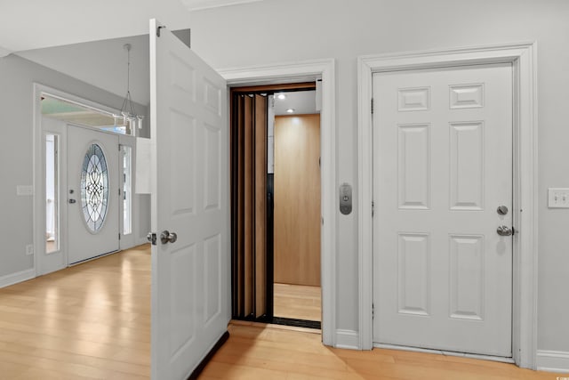 entrance foyer with elevator and light wood-type flooring