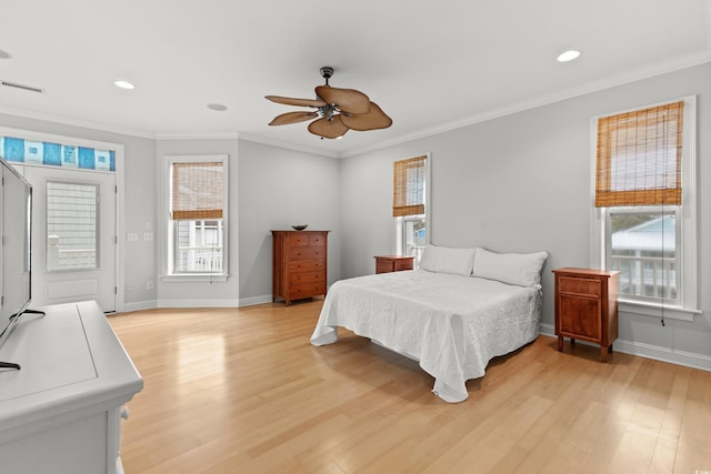 bedroom featuring ceiling fan, light hardwood / wood-style floors, and crown molding