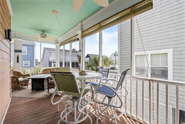 sunroom / solarium featuring ceiling fan