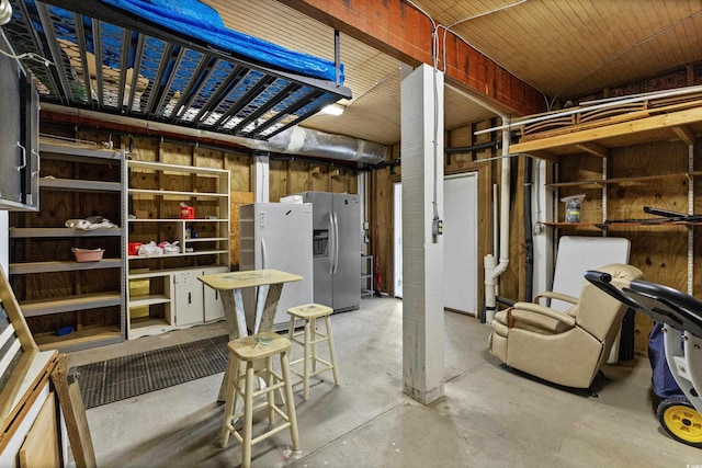 basement featuring stainless steel fridge