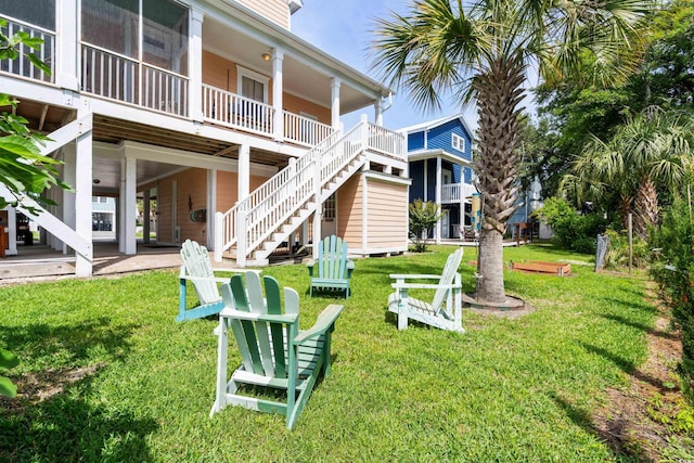 view of home's community with a lawn and a patio