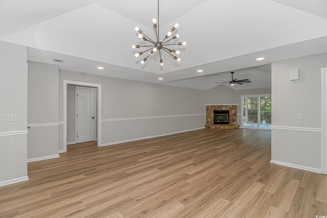 unfurnished living room with a fireplace, high vaulted ceiling, ceiling fan, and light wood-type flooring