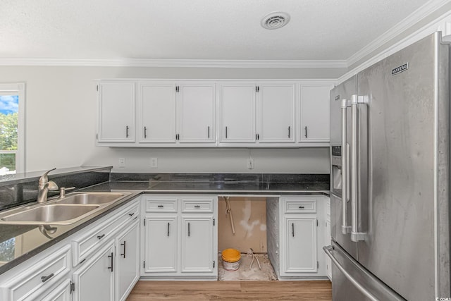 kitchen with white cabinetry, sink, ornamental molding, and high end refrigerator