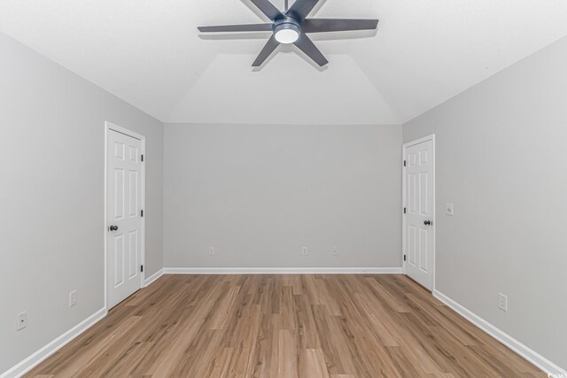 spare room featuring vaulted ceiling, ceiling fan, and light hardwood / wood-style floors