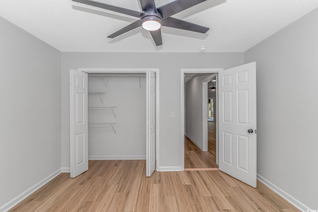 unfurnished bedroom with ceiling fan, light hardwood / wood-style floors, and a closet