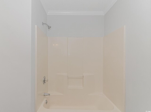 bathroom with ornamental molding and shower / bath combination