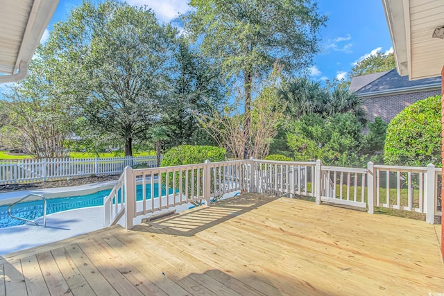 wooden deck featuring a fenced in pool