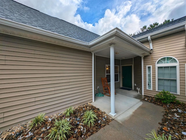 view of exterior entry with a porch