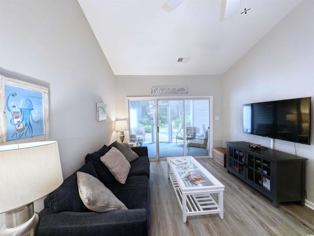 living room featuring lofted ceiling, light wood-type flooring, and ceiling fan