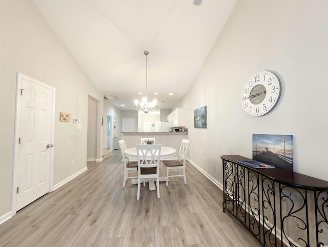 dining room featuring a notable chandelier and light hardwood / wood-style flooring