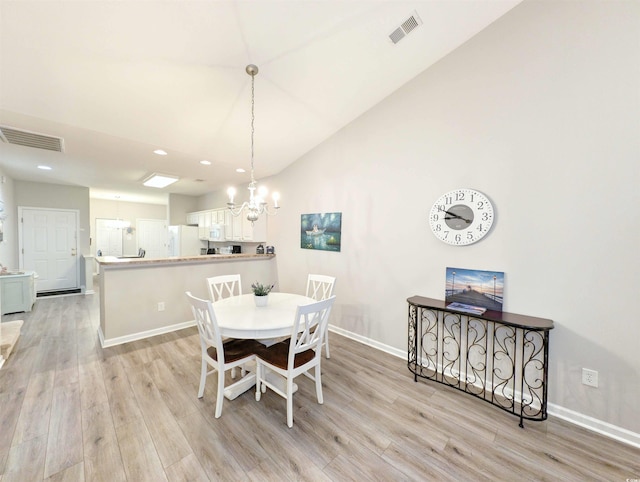 dining area featuring a notable chandelier and light hardwood / wood-style flooring